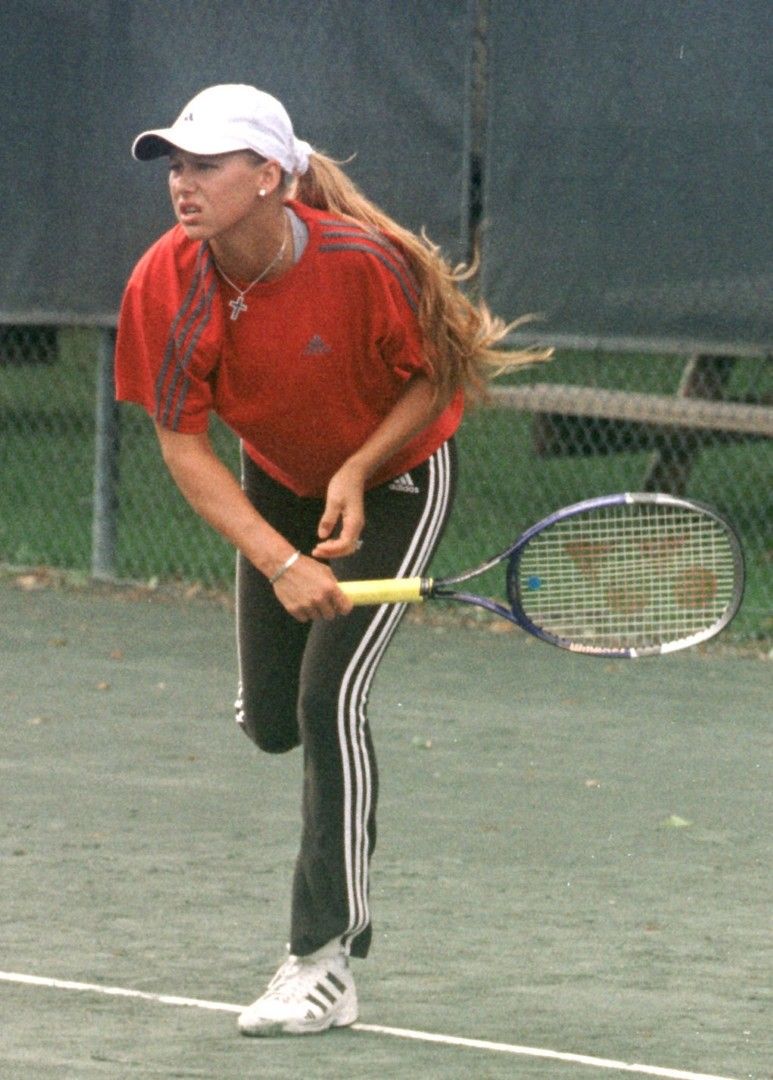 Red tee and tracksuit bottoms mid-rally