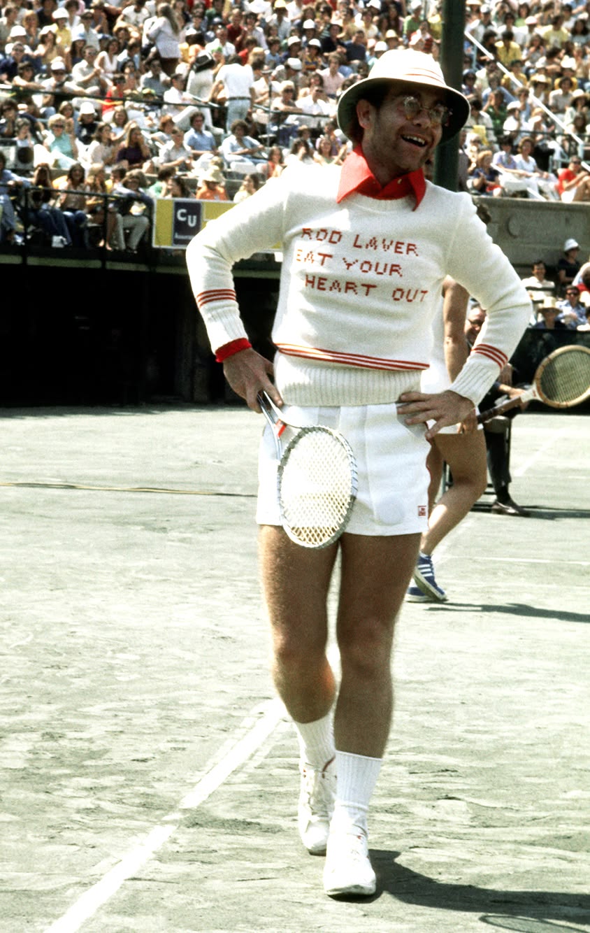 Knitted sweater reading Rod Laver, eat your heart out on a tennis court